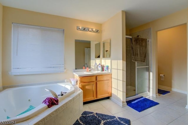 full bath with a jetted tub, tile patterned floors, a shower stall, and vanity