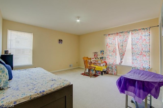 bedroom featuring carpet, visible vents, and baseboards