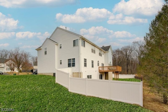 view of property exterior featuring fence and a lawn