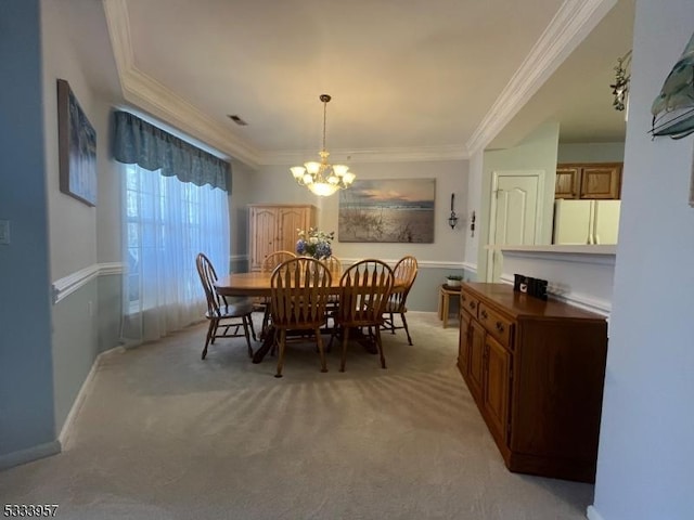 dining area featuring ornamental molding, light carpet, and a notable chandelier