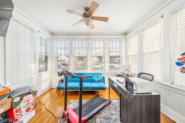 sunroom featuring ceiling fan