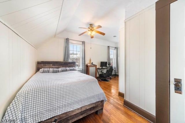 bedroom with lofted ceiling, wood-type flooring, and ceiling fan