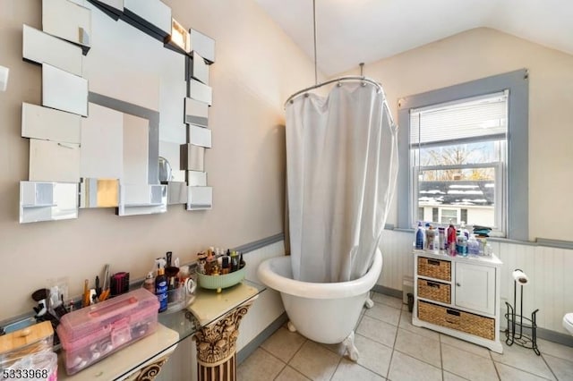 bathroom with vaulted ceiling, tile patterned floors, independent shower and bath, and toilet