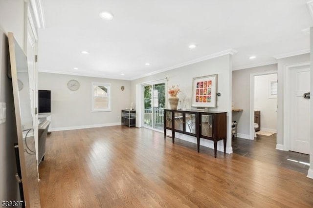 living room with crown molding and wood-type flooring