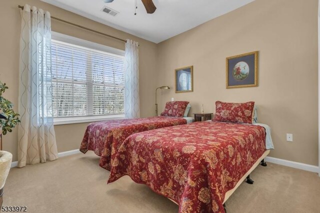 bedroom featuring light carpet and ceiling fan