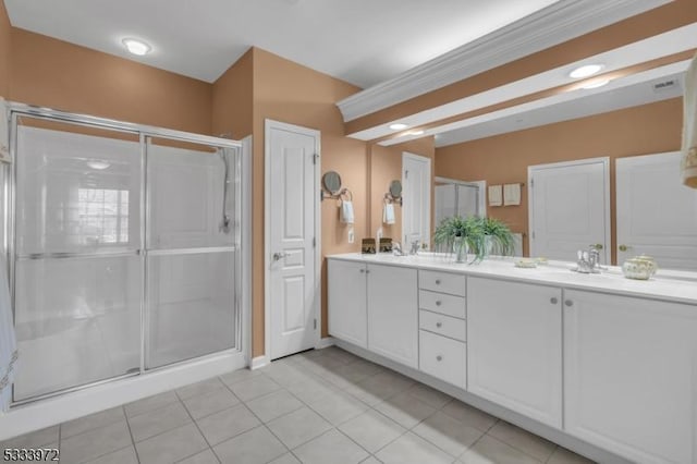 bathroom featuring tile patterned floors, a shower with shower door, and vanity