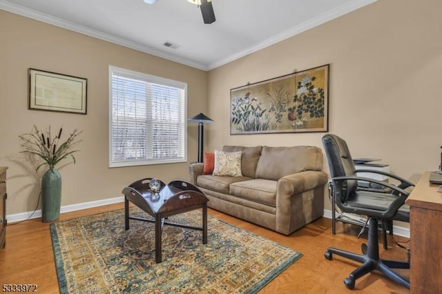 living room with ornamental molding, hardwood / wood-style floors, and ceiling fan