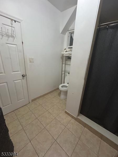 bathroom featuring tile patterned floors and toilet