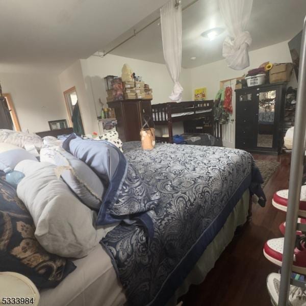 bedroom with dark hardwood / wood-style flooring