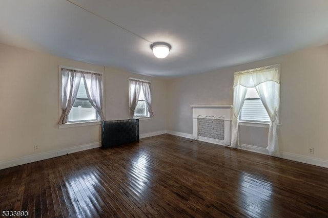 unfurnished living room featuring dark hardwood / wood-style flooring