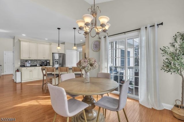 dining space featuring a notable chandelier and light hardwood / wood-style flooring