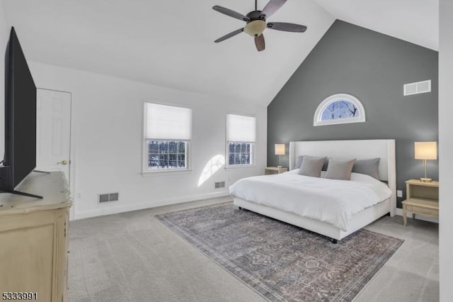 carpeted bedroom featuring high vaulted ceiling and ceiling fan