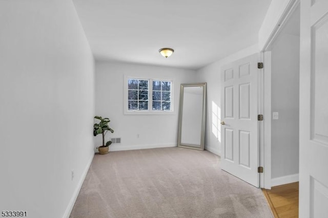 spare room with light colored carpet