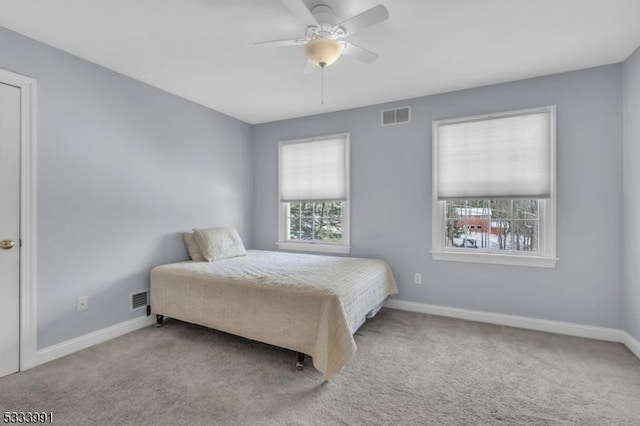 bedroom featuring light colored carpet and ceiling fan