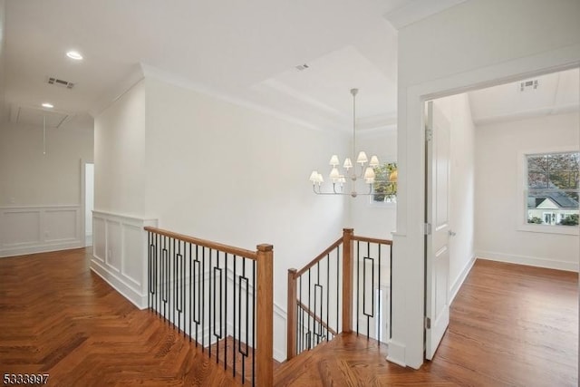 corridor with crown molding and parquet floors