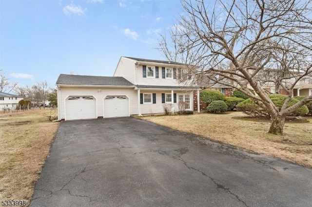 view of front of home with aphalt driveway and an attached garage