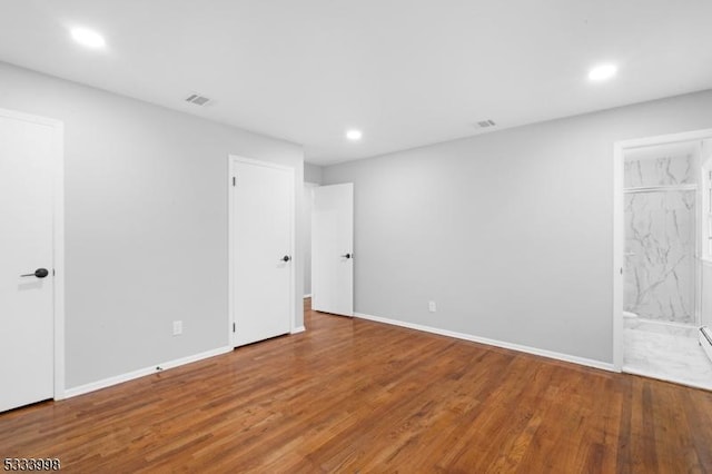 spare room with wood-type flooring