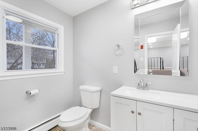 bathroom with vanity, a baseboard heating unit, and toilet