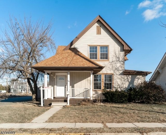 view of front of home featuring covered porch and a front lawn