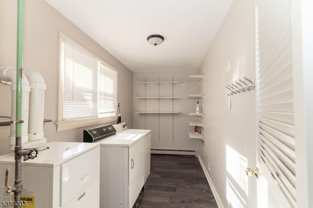 laundry room with washing machine and clothes dryer, a baseboard radiator, and dark wood-type flooring