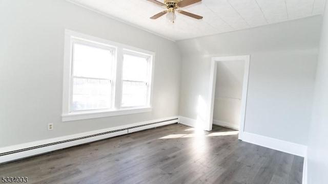 spare room with baseboard heating, ceiling fan, and dark hardwood / wood-style flooring