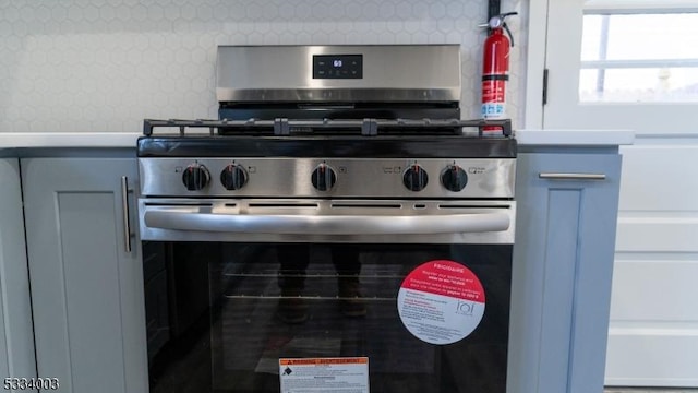 details with tasteful backsplash and stainless steel gas stove