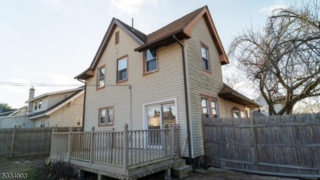 rear view of house featuring a deck