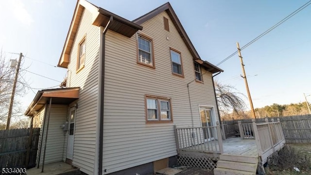 view of property exterior featuring a wooden deck