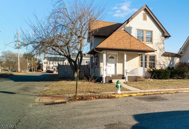 view of property featuring a front yard and a porch