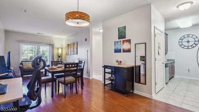 dining space with wood-type flooring