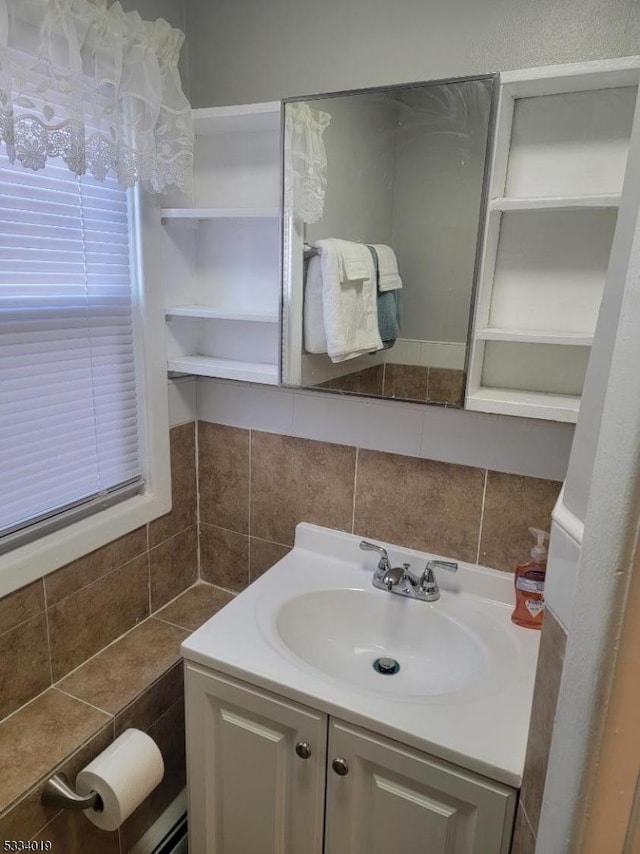 bathroom featuring vanity and tasteful backsplash