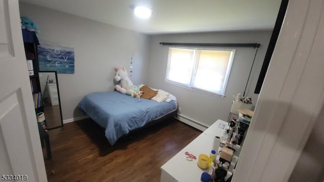 bedroom with a baseboard radiator and dark hardwood / wood-style flooring