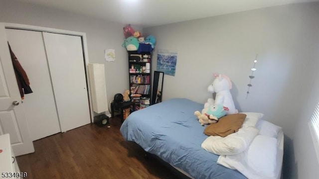 bedroom featuring a closet and dark hardwood / wood-style flooring