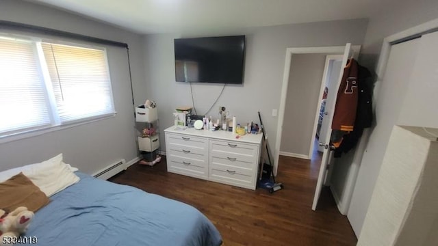 bedroom with a baseboard radiator and dark wood-type flooring