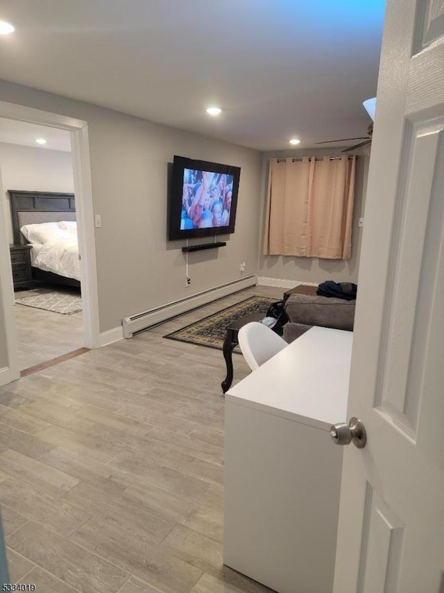 living room featuring light wood-type flooring and baseboard heating