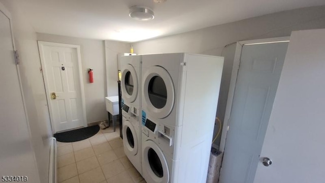 washroom with separate washer and dryer, light tile patterned floors, and stacked washer and dryer