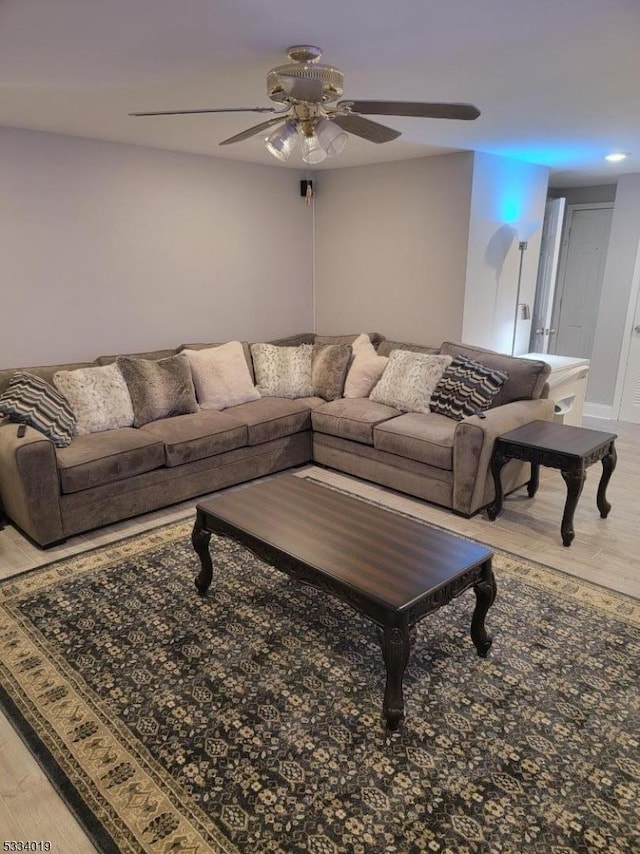 living room with ceiling fan and wood-type flooring