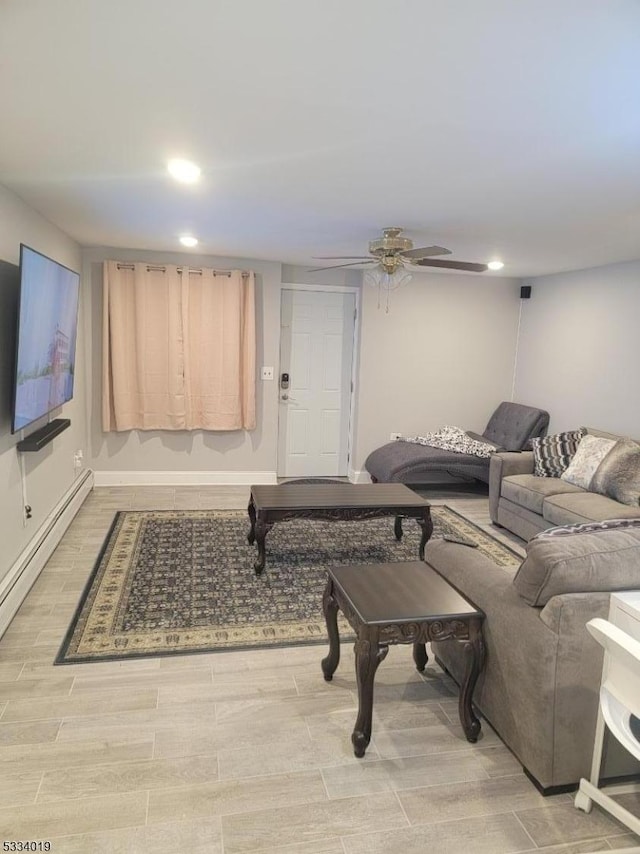 living room featuring ceiling fan and a baseboard heating unit