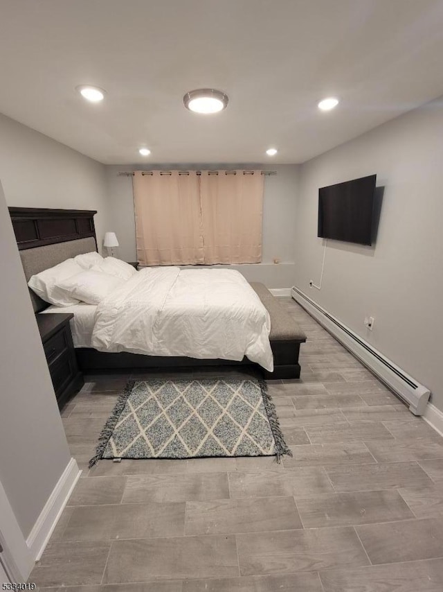 bedroom featuring a baseboard heating unit