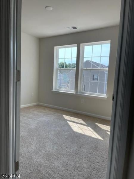 unfurnished room featuring carpet floors