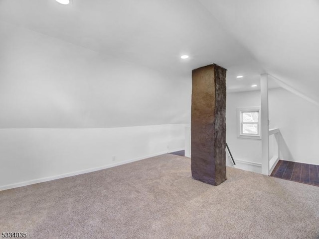 bonus room with carpet floors and lofted ceiling