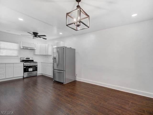 kitchen with white cabinets, pendant lighting, dark hardwood / wood-style flooring, stainless steel appliances, and ceiling fan with notable chandelier