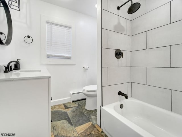 full bathroom with vanity, toilet, baseboard heating, and tiled shower / bath combo