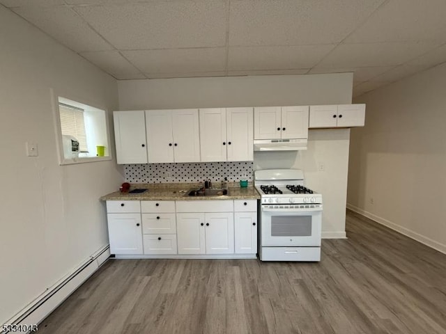 kitchen featuring baseboard heating, sink, white cabinets, a paneled ceiling, and white gas range oven