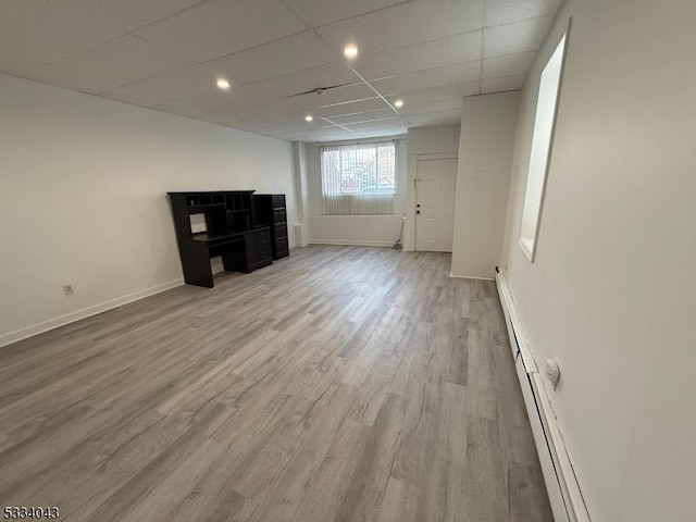 unfurnished room featuring light hardwood / wood-style flooring and a paneled ceiling