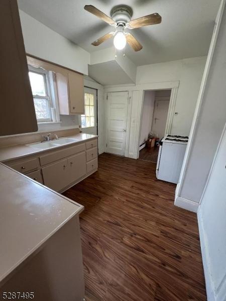 kitchen featuring sink, ceiling fan, white cabinetry, and dark hardwood / wood-style flooring