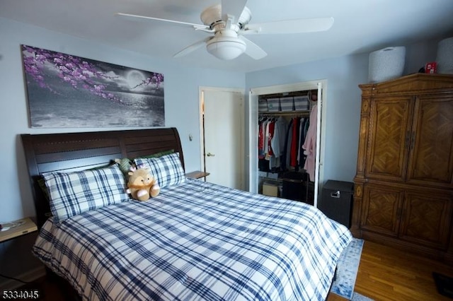 bedroom with wood-type flooring, ceiling fan, and a closet