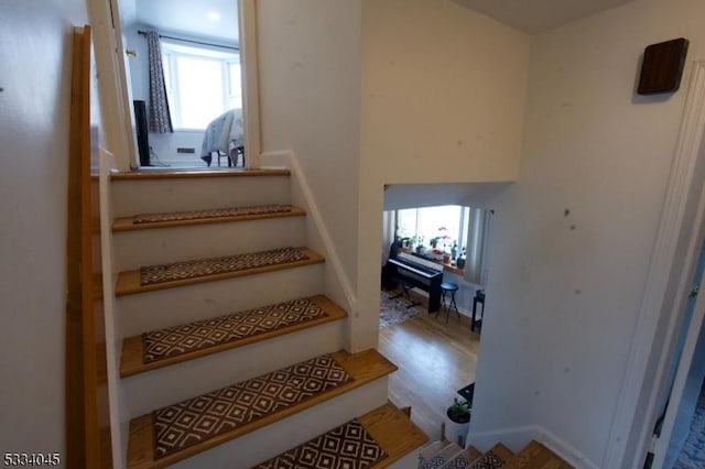 stairway featuring wood-type flooring