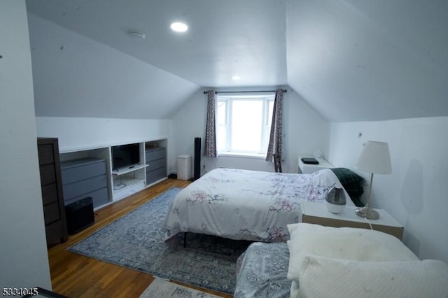 bedroom featuring wood-type flooring and lofted ceiling