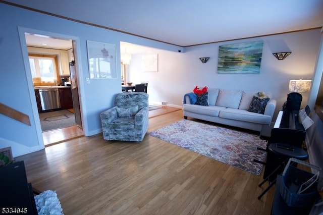 living room featuring ornamental molding and hardwood / wood-style floors